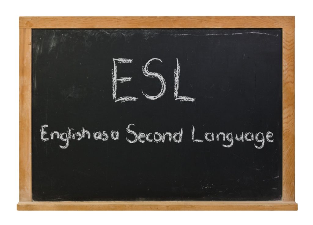 ESL written in white chalk on a black chalkboard.