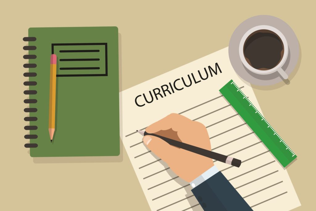 Animated hand writing curriculum on a table with a notebook, coffee, and a ruler.