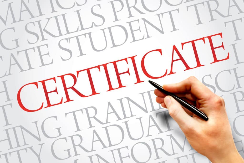 'Certificate’ surrounded by other words and a hand holding a pen.