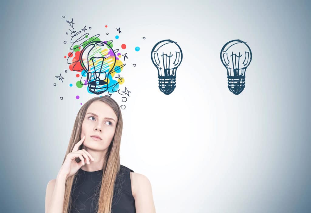 Women pondering with three light bulbs above her.