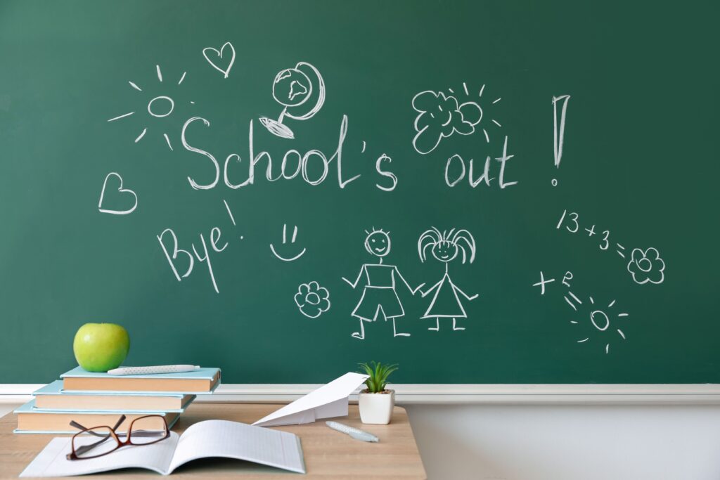 A chalk drawing that reads, “Schools out! Bye!”