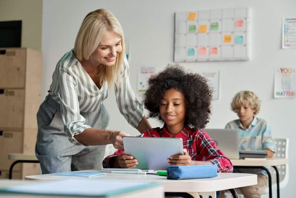 A student communicates with her teacher using a tablet.