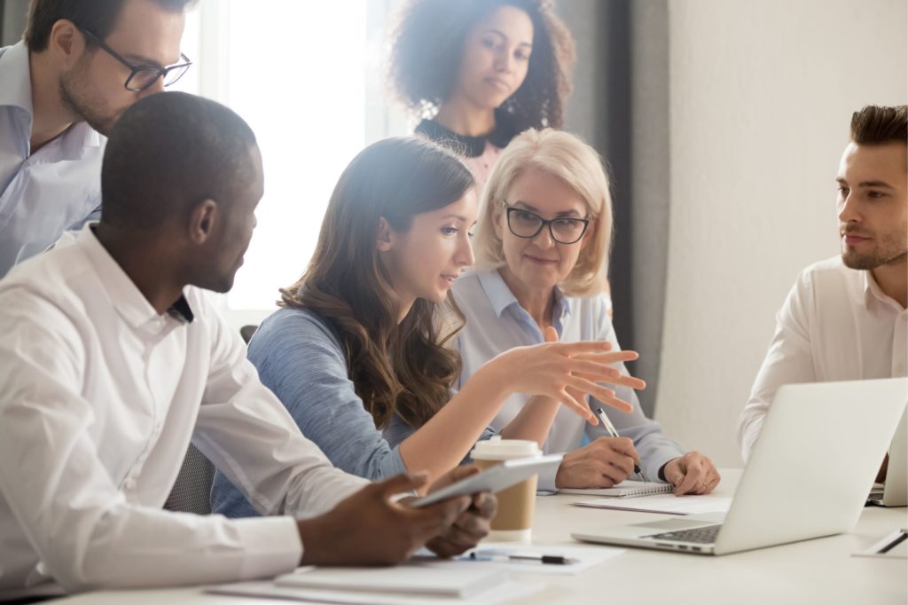 Group of professionals working together around a table.